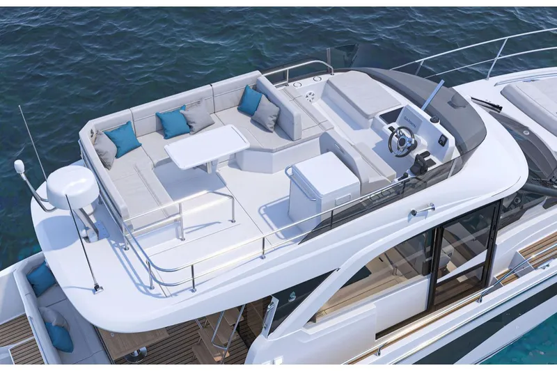 Slide: The Image of 2025 Beneteau Antares 12 yacht with spacious deck, seating, and helm, cruising on water. - 2