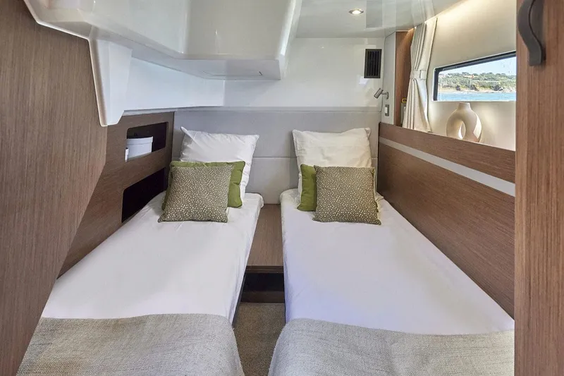 Slide: The Image of 2025 Beneteau Antares 12 cabin with twin beds and modern decor. - 6