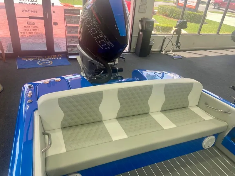 Slide: The Image of 2023 Active Thunder 22 Banshee boat with blue exterior and cushioned seating. - 3