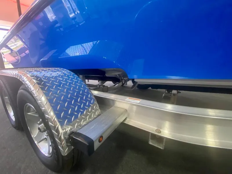 Slide: The Image of 2023 Active Thunder 22 Banshee boat trailer with blue hull and diamond plate fender. - 5