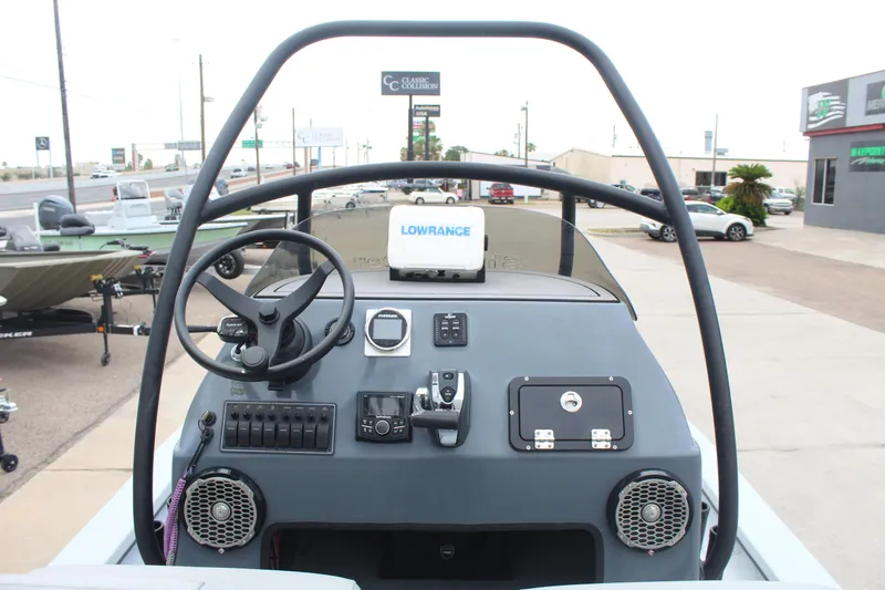Slide: The Image of 2019 Shoalwater 23 Catamaran dashboard with steering wheel and Lowrance navigation system. - 10
