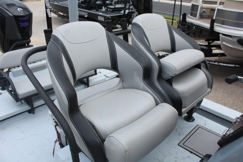 Slide: The Image of 2019 Shoalwater 23 Catamaran interior with dual gray and black captain's chairs. - 13