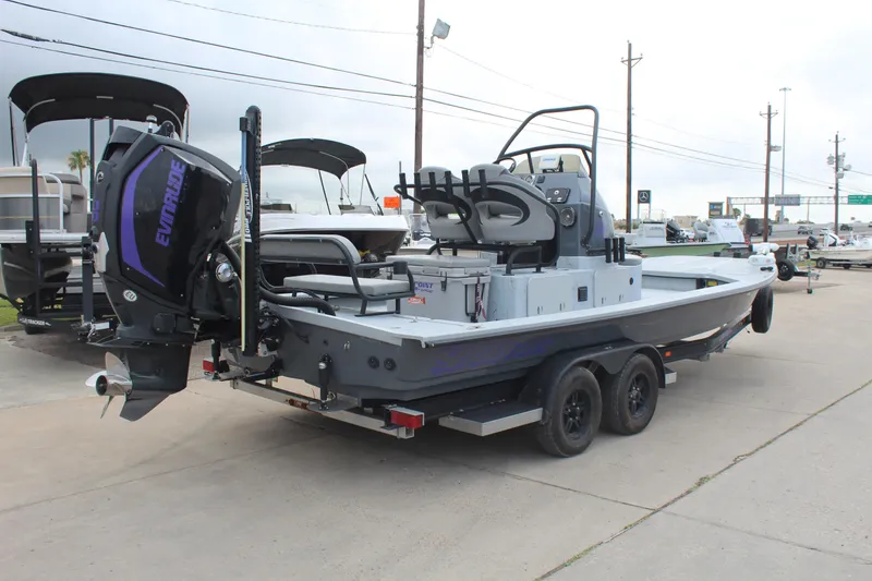Slide: The Image of 2019 Shoalwater 23 Catamaran with Evinrude engine on trailer, parked outdoors. - 5