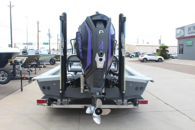 Slide: The Image of 2019 Shoalwater 23 Catamaran with Evinrude engine on trailer, parked outdoors. - 6