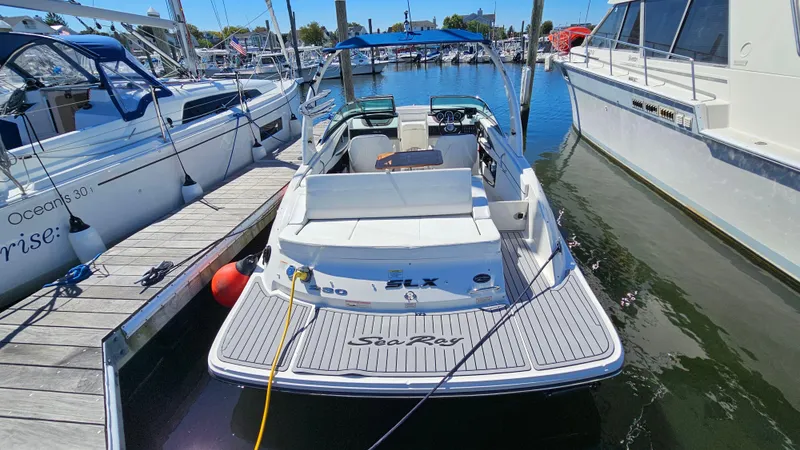 Slide: The Image of 2016 Sea Ray 230 SLX boat docked at marina, rear view. - 10