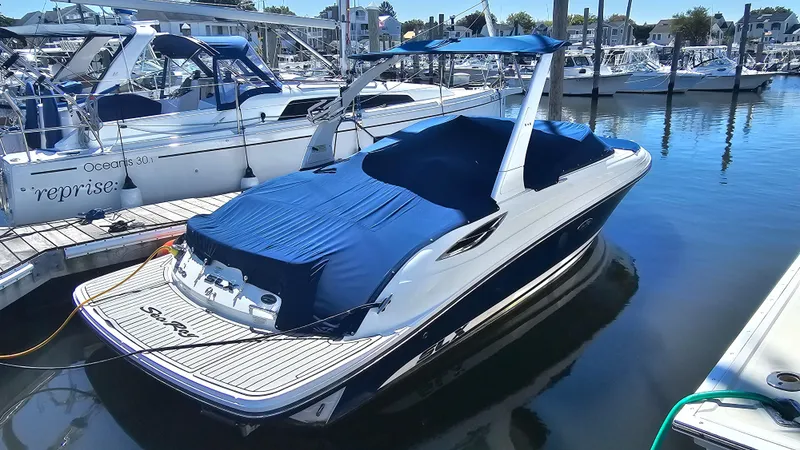 Slide: The Image of 2016 Sea Ray 230 SLX boat docked in marina, covered with blue tarp. - 14