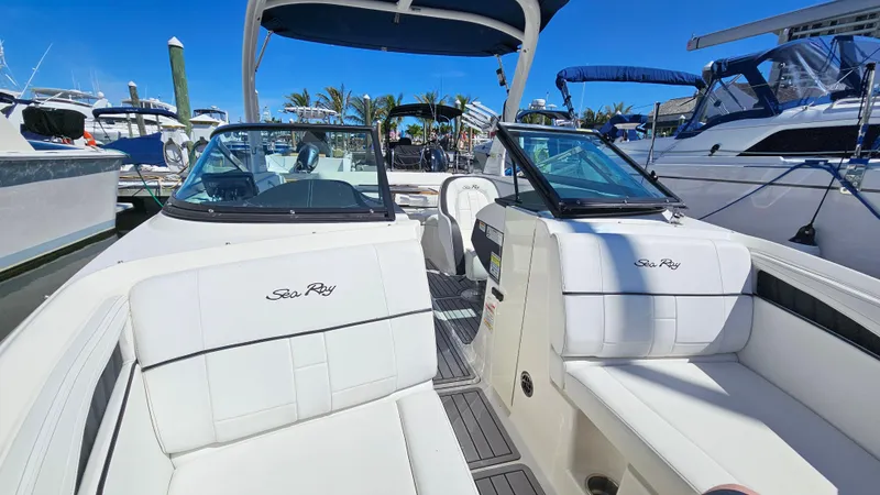 Slide: The Image of 2016 Sea Ray 230 SLX boat interior with white seating at marina. - 23
