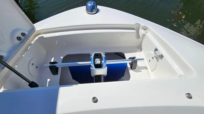 Slide: The Image of 2016 Sea Ray 230 SLX boat anchor storage compartment with open hatch. - 25