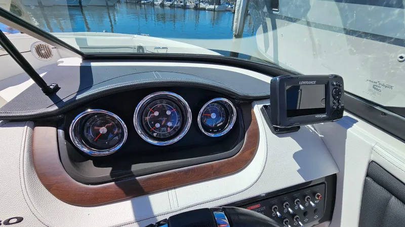 Slide: The Image of Dashboard of 2016 Sea Ray 230 SLX boat with gauges and navigation system. - 27