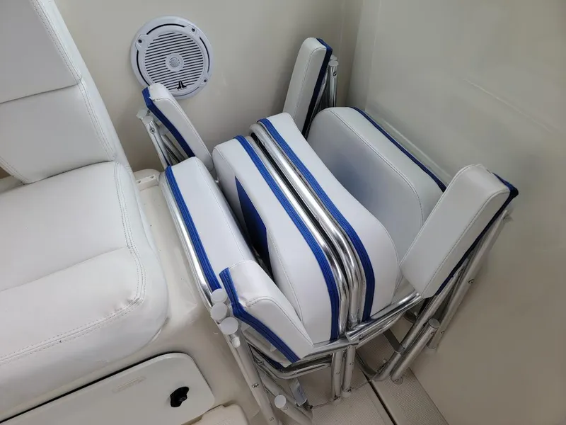 Slide: The Image of Folded white and blue boat seats on a 1995 Tiara Yachts 3100 Open. - 12