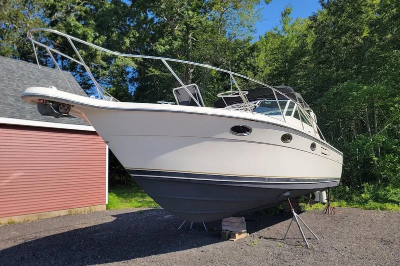 Slide: The Image of 1995 Tiara Yachts 3100 Open with 2017 FWC engines, parked outdoors. - 13