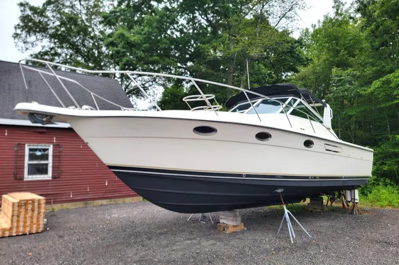 Slide: The Image of 1995 Tiara Yachts 3100 Open on stands, featuring 2017 FWC engines, outdoors. - 14