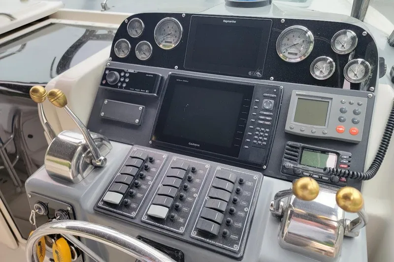 Slide: The Image of Control panel of a 1995 Tiara Yachts 3100 Open, featuring modern navigation instruments. - 16