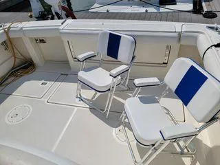 Slide: The Image of 1995 Tiara Yachts 3100 Open deck with two white and blue chairs. - 21