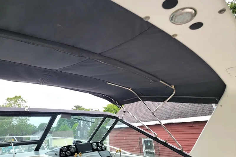 Slide: The Image of Tiara Yachts 3100 Open 1995, featuring a covered helm area with modern design elements. - 22