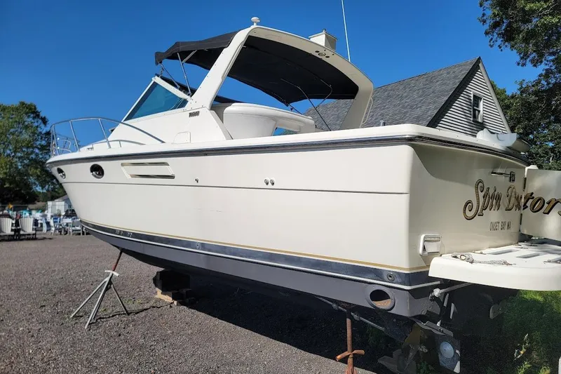 Slide: The Image of 1995 Tiara Yachts 3100 Open boat with 2017 FWC engines, docked outdoors. - 27