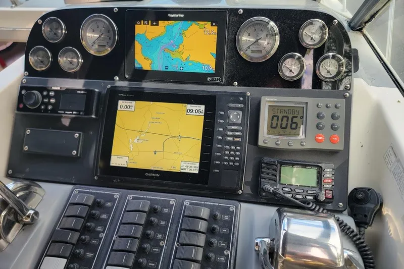 Slide: The Image of Control panel of a 1995 Tiara Yachts 3100 Open, featuring navigation and communication equipment. - 3