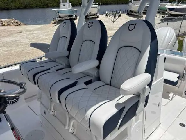 Slide: The Image of 2025 Sea Fox 328 Commander boat seats with elegant white and navy design. - 10