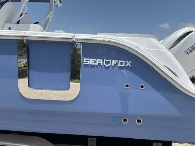Slide: The Image of 2025 Sea Fox 328 Commander boat, blue hull, side view with logo. - 6
