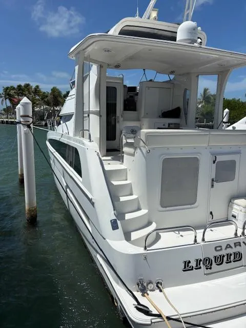 Slide: The Image of 2006 Carver 43 Motor Yacht docked, featuring spacious deck and elegant design. - 2