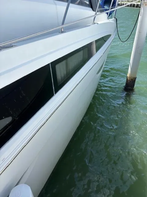 Slide: The Image of 2006 Carver 43 Motor Yacht docked in clear water, side view. - 23
