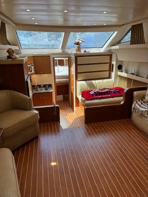 Slide: The Image of Interior of 2006 Carver 43 Motor Yacht with wood flooring and cozy seating area. - 26