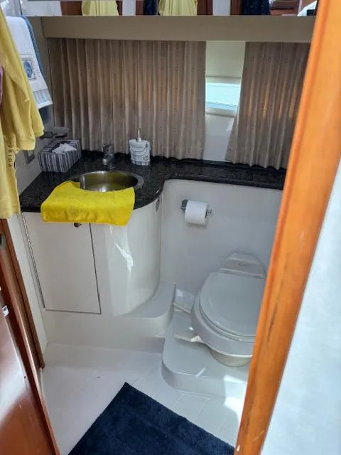 Slide: The Image of Bathroom interior of 2006 Carver 43 Motor Yacht with sink, toilet, and yellow towel. - 33