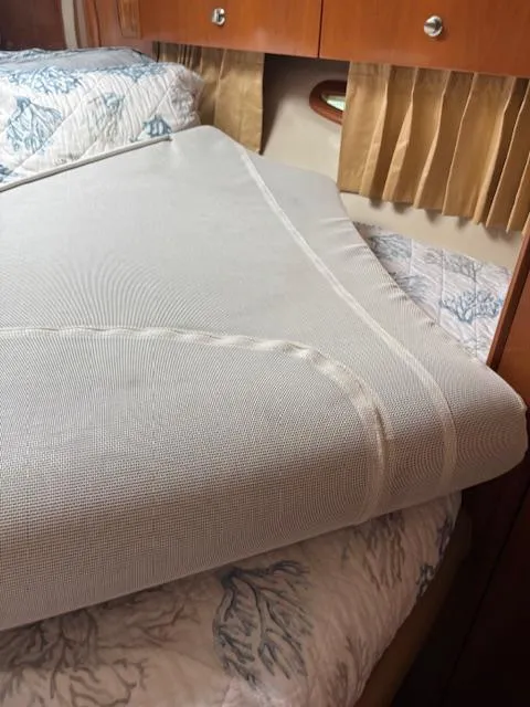 Slide: The Image of Interior of 2006 Carver 43 Motor Yacht with neatly made bed and wooden cabinetry. - 36