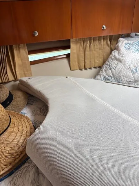 Slide: The Image of Interior of 2006 Carver 43 Motor Yacht with bed, pillows, and straw hats. - 37
