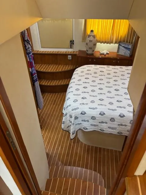 Slide: The Image of Interior of 2006 Carver 43 Motor Yacht with cozy bedroom and wooden flooring. - 44