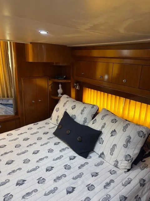 Slide: The Image of Luxurious bedroom interior of 2006 Carver 43 Motor Yacht with elegant bedding and warm lighting. - 48