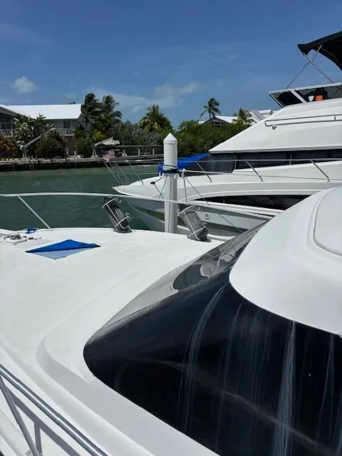 Slide: The Image of 2006 Carver 43 Motor Yacht docked in a sunny marina setting. - 10