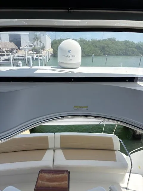 Slide: The Image of 2006 Carver 43 Motor Yacht interior with seating, overlooking marina and water. - 15