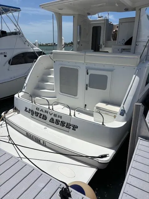 Slide: The Image of 2006 Carver 43 Motor Yacht docked, rear view, named "Liquid Asset," in Marathon, FL. - 20