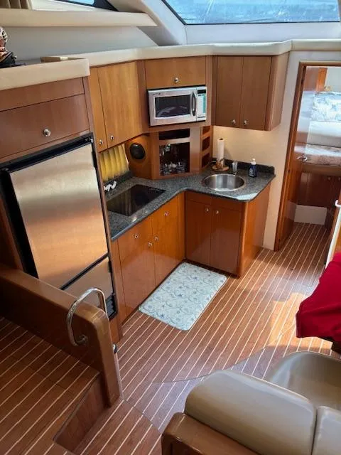 Slide: The Image of Interior of 2006 Carver 43 Motor Yacht with kitchen and wood flooring. - 29
