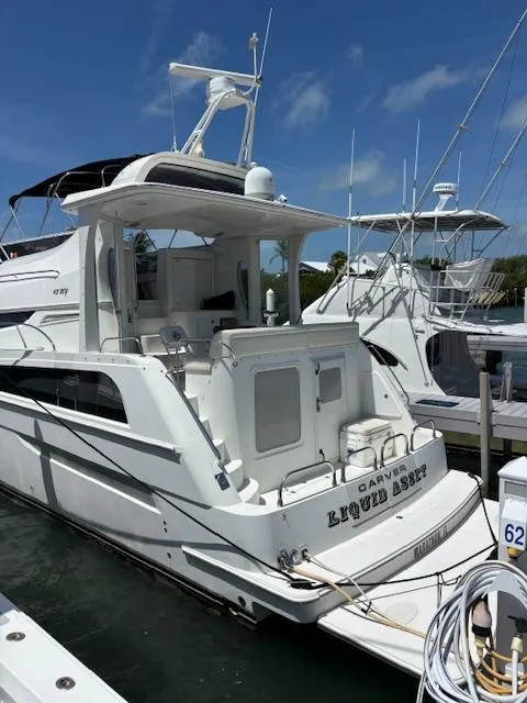 Slide: The Image of 2006 Carver 43 Motor Yacht docked at marina under clear blue sky. - 3