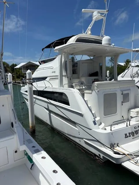 Slide: The Image of 2006 Carver 43 Motor Yacht docked at marina under clear blue sky. - 4