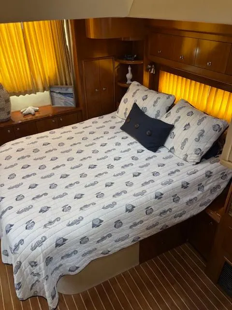 Slide: The Image of Cozy bedroom in 2006 Carver 43 Motor Yacht with nautical-themed bedding and warm lighting. - 45