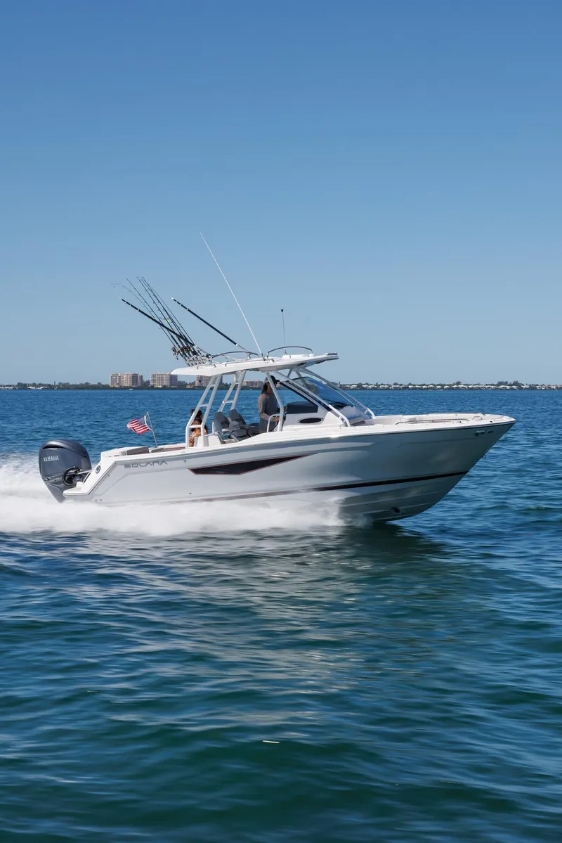 Slide: The Image of 2026 Solara S-250 CW boat cruising on open water under clear blue sky. - 2