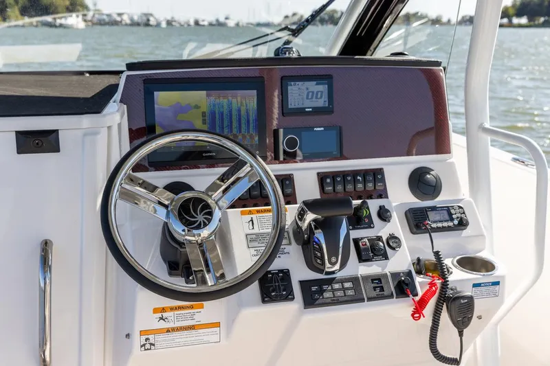 Slide: The Image of Control panel of 2026 Solara S-250 CW boat with steering wheel and navigation instruments. - 5