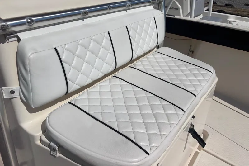 Slide: The Image of White quilted seating on 2003 KenCraft 235 Challenger boat, featuring black trim accents. - 27