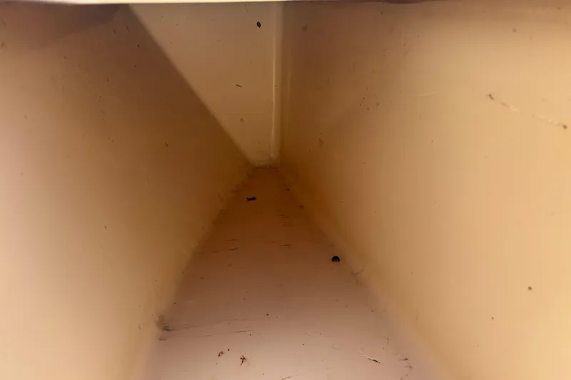 Slide: The Image of Interior compartment of a 2003 KenCraft 235 Challenger boat, showing storage space. - 28