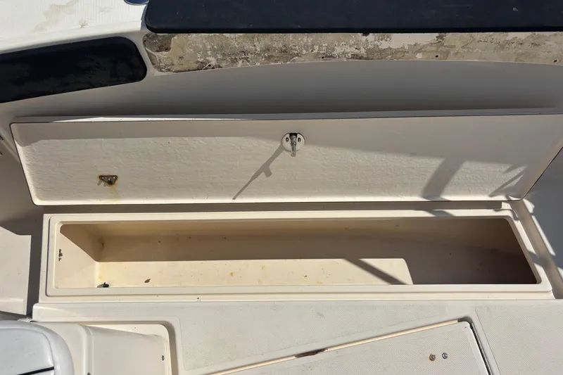 Slide: The Image of Open storage compartment on a 2003 KenCraft 235 Challenger boat. - 29