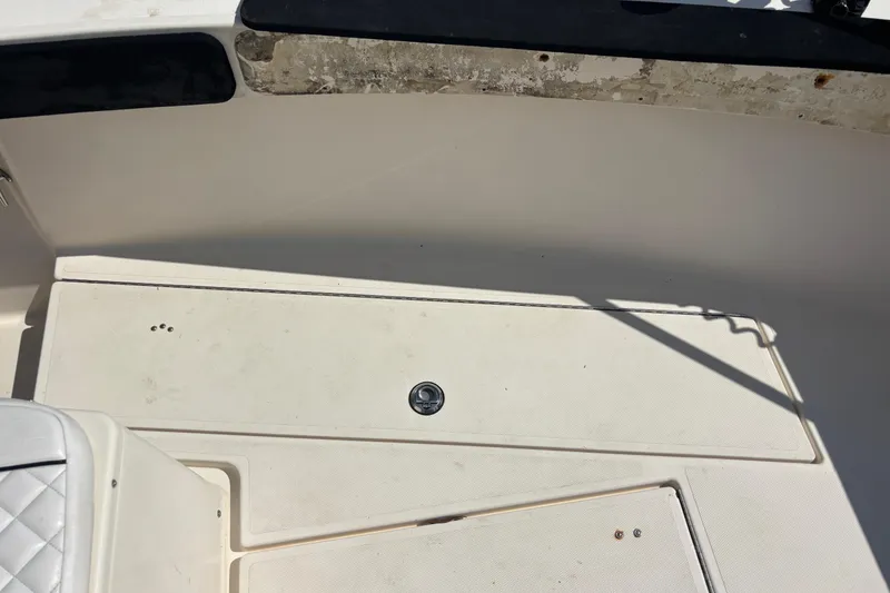 Slide: The Image of 2003 KenCraft 235 Challenger boat deck with storage compartment and seating area. - 30