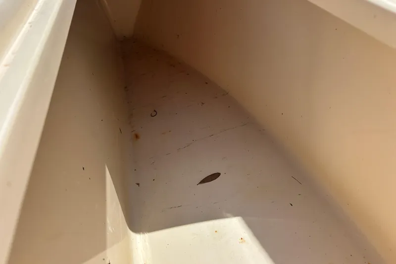Slide: The Image of Interior view of a 2003 KenCraft 235 Challenger boat compartment, showing light debris. - 34