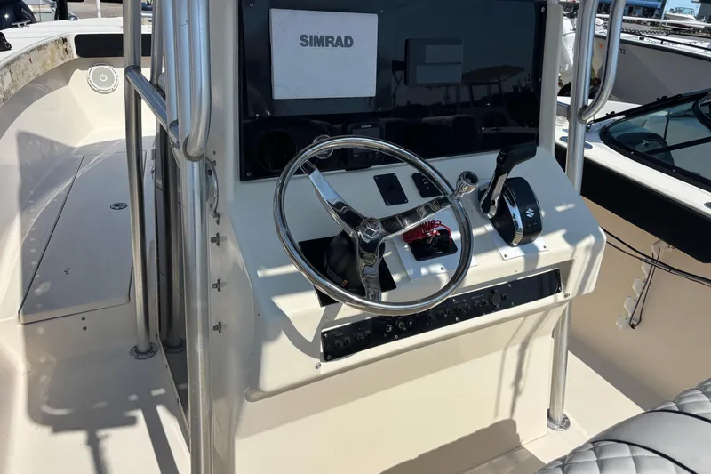 Slide: The Image of 2003 KenCraft 235 Challenger boat console with steering wheel and Simrad display. - 4