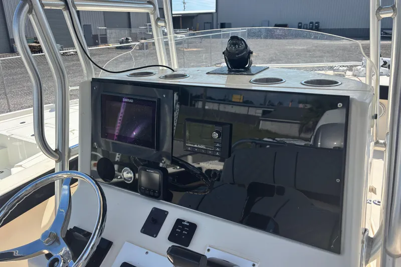 Slide: The Image of 2003 KenCraft 235 Challenger boat dashboard with navigation equipment and steering wheel. - 42