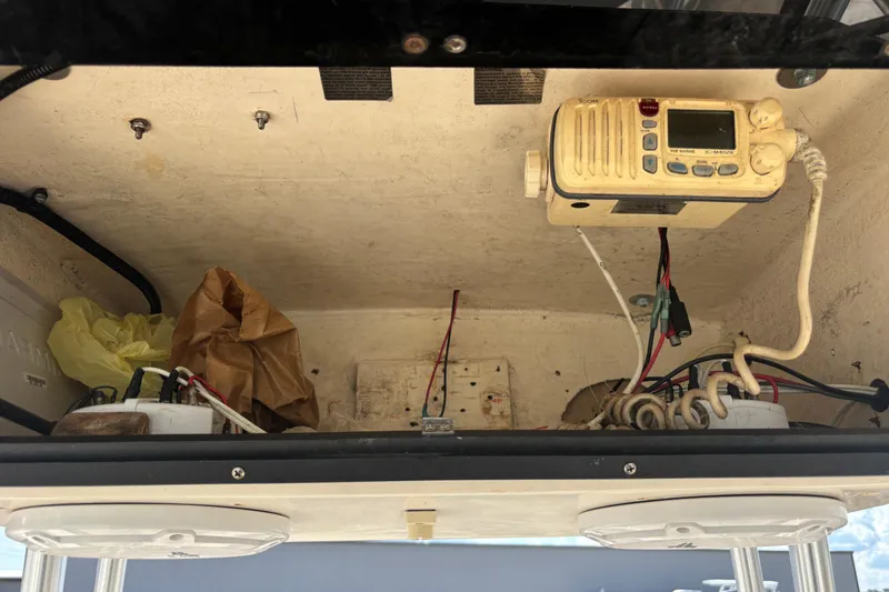 Slide: The Image of 2003 KenCraft 235 Challenger boat electronics compartment with radio and wiring. - 47