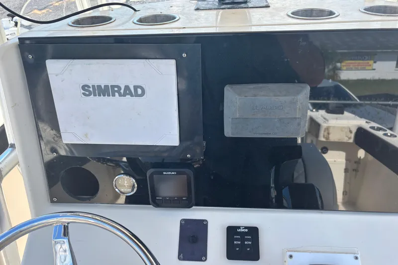 Slide: The Image of Console of a 2003 KenCraft 235 Challenger with Simrad and JL Audio equipment. - 48