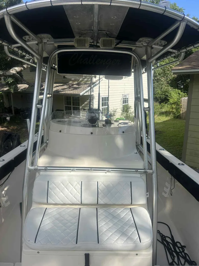 Slide: The Image of 2003 KenCraft 235 Challenger boat with T-top and cushioned seating. - 5